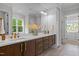 Elegant primary bathroom with double vanity, dark wood cabinets, and a large mirror at 7813 Ailesbury Rd, Wake Forest, NC 27587