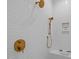 Modern bathroom features wavy tile walls, golden fixtures, and built in shelving for storage at 7813 Ailesbury Rd, Wake Forest, NC 27587