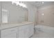 Bathroom vanity with drawers and a large mirror, plus a shower-tub combination in the background at 7813 Ailesbury Rd, Wake Forest, NC 27587