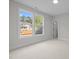 Bedroom featuring neutral carpet, white walls, two windows, and a view of the yard at 7813 Ailesbury Rd, Wake Forest, NC 27587