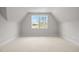 Lofted bedroom with neutral carpet, angled ceiling, one window, and bright natural light at 7813 Ailesbury Rd, Wake Forest, NC 27587