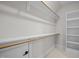 Bright closet featuring built-in shelving, rods, and ample storage space at 7813 Ailesbury Rd, Wake Forest, NC 27587
