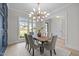 A stylish dining space with a contemporary chandelier, modern chairs, and plenty of natural light at 7813 Ailesbury Rd, Wake Forest, NC 27587