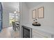 Partial view of dining room with access to a bar area with a wine fridge and decor at 7813 Ailesbury Rd, Wake Forest, NC 27587
