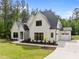 A spacious, white brick home with an attached two-car garage, complemented by a well-manicured lawn at 7813 Ailesbury Rd, Wake Forest, NC 27587