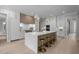 Modern kitchen with a large island with a quartz countertop and sleek white cabinetry at 7813 Ailesbury Rd, Wake Forest, NC 27587