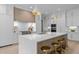A modern kitchen with a large island, pendant lighting, state-of-the-art appliances, and custom cabinetry at 7813 Ailesbury Rd, Wake Forest, NC 27587