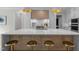 A contemporary kitchen featuring a spacious island with seating, modern fixtures, and sleek finishes at 7813 Ailesbury Rd, Wake Forest, NC 27587