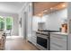 Gourmet kitchen featuring stainless steel appliances and a gas range with a decorative hood at 7813 Ailesbury Rd, Wake Forest, NC 27587