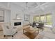 Open living room with fireplace, coffered ceiling and access to outdoor living space at 7813 Ailesbury Rd, Wake Forest, NC 27587
