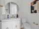 Stylish powder room with marble countertop, gold accents, and round mirror at 7813 Ailesbury Rd, Wake Forest, NC 27587