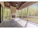 Inviting screened-in porch with a stone fireplace, ceiling fan, and wooded views for comfortable outdoor living at 7813 Ailesbury Rd, Wake Forest, NC 27587