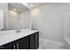Bathroom with a long dark wood vanity, white countertop, and tub-shower combo at 85 Windchime Ct, Fuquay Varina, NC 27526
