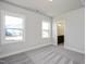 Neutral bedroom with two bright windows and an ensuite bathroom with a dark wood vanity at 85 Windchime Ct, Fuquay Varina, NC 27526