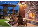 Inviting outdoor fireplace with stone surround and cozy seating area at 85 Windchime Ct, Fuquay Varina, NC 27526