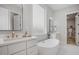 Bathroom with double vanity, freestanding tub, and walk-in closet at 1245 Golfers Vw, Pittsboro, NC 27312