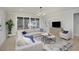Bright living room with sectional sofa, coffee table, and large windows at 1245 Golfers Vw, Pittsboro, NC 27312
