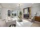Living room with fireplace, large windows, and access to patio at 1245 Golfers Vw, Pittsboro, NC 27312