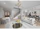 Open living area with modern light fixture and stairs at 1245 Golfers Vw, Pittsboro, NC 27312