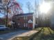 Front view of brick home with trees and driveway at 1714 Fox Hollow Dr, Raleigh, NC 27610