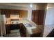 Small kitchen with wood cabinets, stove and double sink at 1714 Fox Hollow Dr, Raleigh, NC 27610
