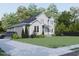 Two-story house with gray and white siding, landscaping, driveway, and car at 183 Lookout Rdg, Pittsboro, NC 27312