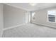 Spacious carpeted bedroom with two windows, white trim, and soft neutral walls, creating a bright, airy feel at 2908 Frances Marie Ln, Raleigh, NC 27603