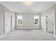 Bedroom with neutral walls, carpet, and two windows, providing a bright and inviting space at 2908 Frances Marie Ln, Raleigh, NC 27603