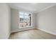 Bright bedroom features hardwood floors and a large window with a view at 2908 Frances Marie Ln, Raleigh, NC 27603