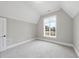 Neutral bedroom with a large window, grey walls, and plush carpeting, offering a calming and bright atmosphere at 2908 Frances Marie Ln, Raleigh, NC 27603