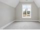 Empty bedroom features a large window and neutral decor for a serene and inviting space at 2908 Frances Marie Ln, Raleigh, NC 27603