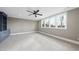 Neutral bedroom featuring a ceiling fan, custom cabinets, and a bright window to enhance the airy feel at 2908 Frances Marie Ln, Raleigh, NC 27603