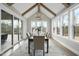 Formal dining room with vaulted ceiling, wood beams, modern chandelier, and ample natural light overlooking the backyard at 2908 Frances Marie Ln, Raleigh, NC 27603