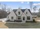 Stunning new construction white brick home with modern black trim, professional landscaping, and inviting curb appeal at 2908 Frances Marie Ln, Raleigh, NC 27603