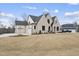 Stunning white brick home exterior featuring a three-car garage and well-manicured lawn at 2908 Frances Marie Ln, Raleigh, NC 27603