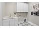 Bright laundry room with white cabinets, quartz countertops and stylish tile flooring at 2908 Frances Marie Ln, Raleigh, NC 27603