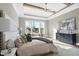 Light-filled main bedroom features a tray ceiling, exposed wood beams, and hardwood floors at 2908 Frances Marie Ln, Raleigh, NC 27603