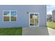 New home has a sliding glass door leading to a cozy back patio and a grassy backyard at 420 Blue Aspen Dr, Fuquay Varina, NC 27526