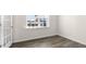 Well-lit room featuring a window, neutral walls, and wood-look flooring at 420 Blue Aspen Dr, Fuquay Varina, NC 27526