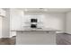 Kitchen featuring an island with granite countertops, stainless appliances and white cabinets at 420 Blue Aspen Dr, Fuquay Varina, NC 27526