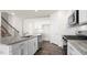 Kitchen featuring an island with granite countertops, stainless appliances and white cabinets at 420 Blue Aspen Dr, Fuquay Varina, NC 27526