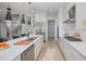 Modern kitchen with white cabinets, stainless steel appliances, and island at 45 Quail Pt, Pittsboro, NC 27312
