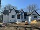 New two-story home featuring a white brick and siding exterior and black roof accents at 4804 Jefferson Ln, Raleigh, NC 27616