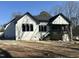 Rear view of new construction home with a covered porch and dark trim at 4804 Jefferson Ln, Raleigh, NC 27616