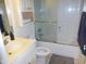 Clean bathroom with shower/tub combo, vanity, and linen storage at 513 Port Dr, Henderson, NC 27537