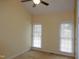Bedroom with two windows, neutral walls and carpet at 513 Port Dr, Henderson, NC 27537