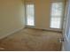 Bright bedroom with neutral carpeting and two large windows at 513 Port Dr, Henderson, NC 27537