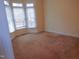Bright bedroom featuring bay windows and neutral carpeting at 513 Port Dr, Henderson, NC 27537