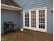 Wooden deck with white French doors and grill at 513 Port Dr, Henderson, NC 27537