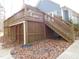 Multi-level deck with stairs and storage shed below at 513 Port Dr, Henderson, NC 27537